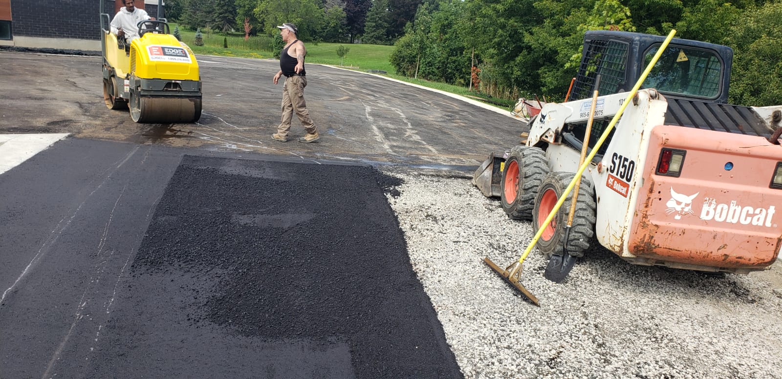 Parking lot excavation with bobcat